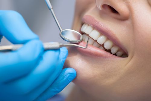 Dentist examining paitent (medium).jpg